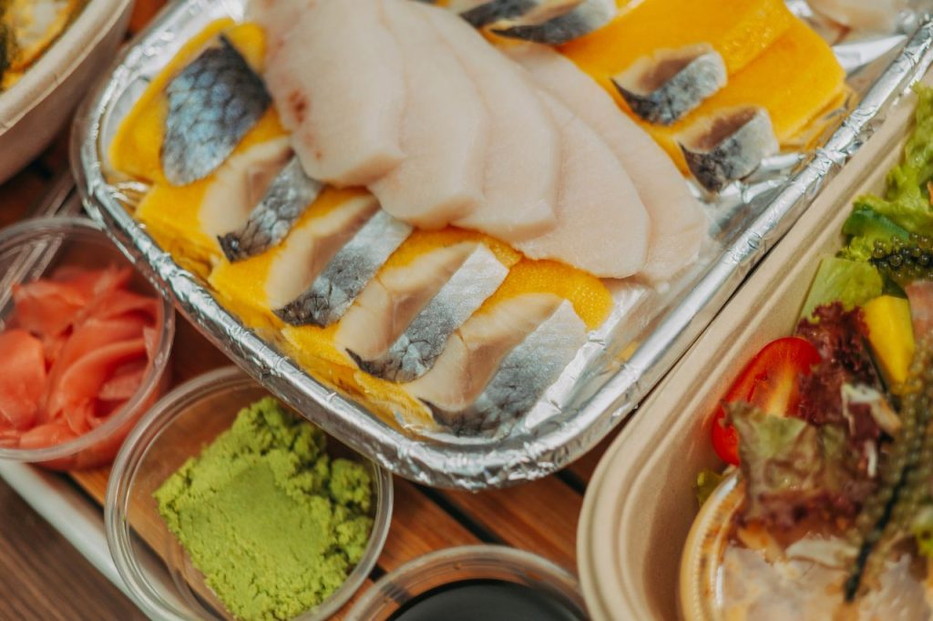 A vibrant sashimi platter featuring fresh fish slices with wasabi and ginger, perfect for seafood enthusiasts.